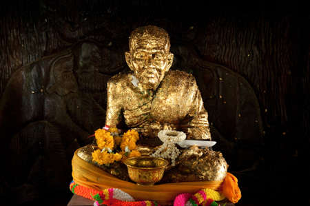 Monk statue with gold leafの写真素材