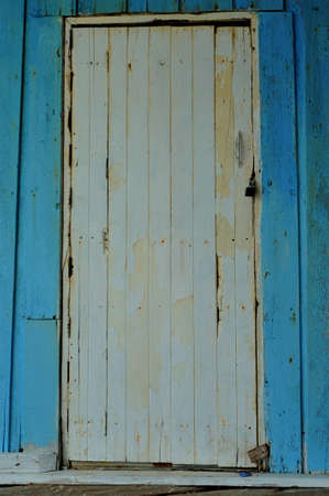 White door on blue wallの写真素材