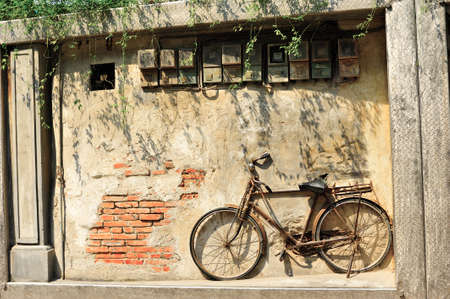 Old bicycle on vintage house, Chinaの写真素材
