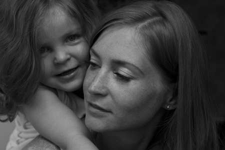 The girl hugging her motherの写真素材