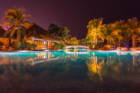 Swimming pool in tropical resort hotel at nightのeditorial素材