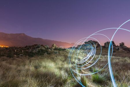 Abstract spiral light painting in a field
