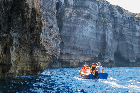Tourists visiting cliffs Gozo Island, Maltaの写真素材