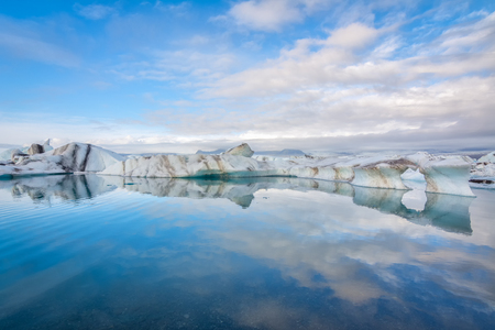 Icebergs in Jokulsarlon glacial lake reflected in water, Icelandの写真素材