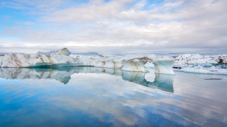 Icebergs in Jokulsarlon glacial lake reflected in water, Iceland