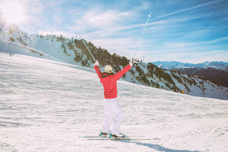 Young female skier enjoying a sunny day in the snowの写真素材