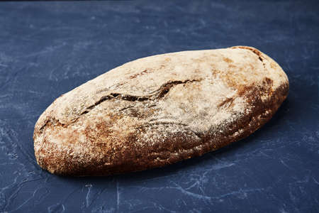Bakery - gold rustic crusty loaves of bread and buns on blue chalkboard background.