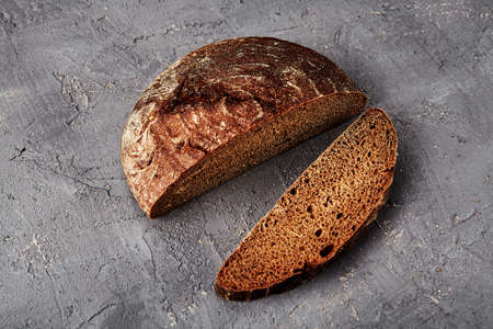 Bakery - gold rustic crusty loaves of bread and buns on gray chalkboard background.