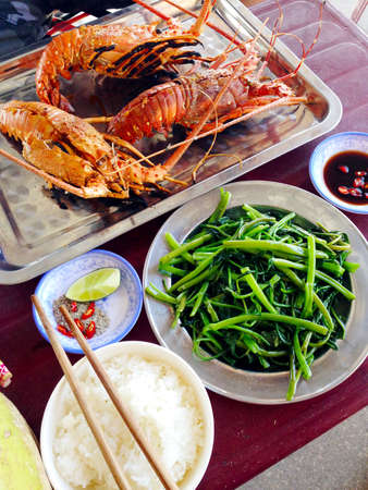 grilled lobster and stir fried morning glory food setの写真素材
