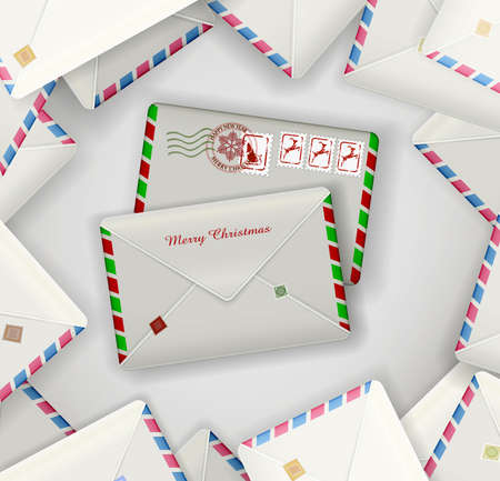 two Christmas mail envelopes on the pile of another daily, holiday mail envelopes,の写真素材