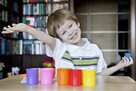 Happy child with plasticineの写真素材