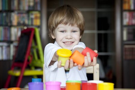 Happy child with plasticineの写真素材