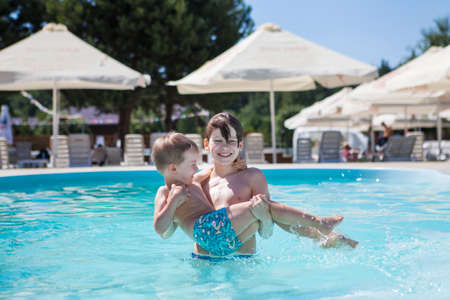 Two brothers near the pool on a summer dayの写真素材