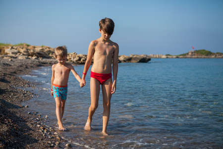 Brothers rest by the seaの写真素材