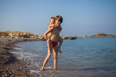 Brothers rest by the seaの写真素材