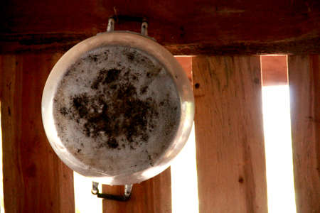 old pot on wall- retro equipment of grandmother cookingの写真素材