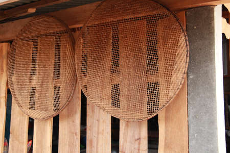 winnowing basket, bamboo threshing basket use for food airing hang  on  wood wallの写真素材