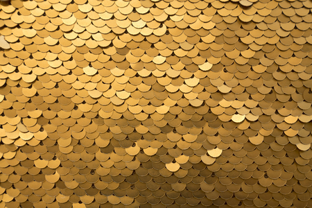 Golden and iridescent sequins texture backgroundの写真素材