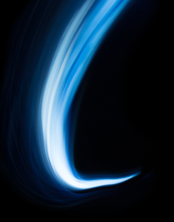 Glowing shiny curve light trail lines effect in black background.の写真素材