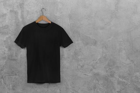 Black Blank Cotton Tshirt Hanging Center Gray Concrete Empty Wall Backgroundの写真素材