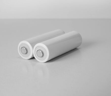 Close up white AA batteries over white backgroundの写真素材