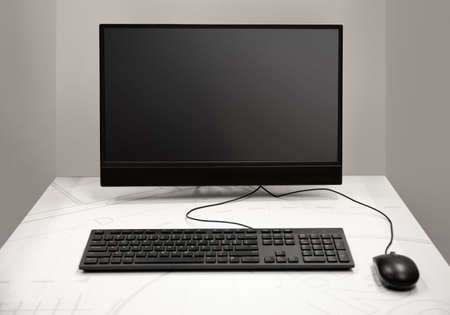 Desktop computer inside a private room with wall