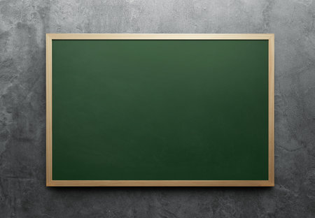 Green chalkboard with a wooden frame on the concrete wallの写真素材