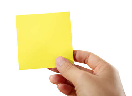 Hand holding a yellow sticky note isolated on white with clipping path