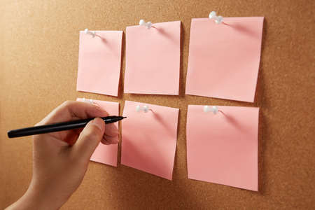 Close-up of a female hand making notes with a marker