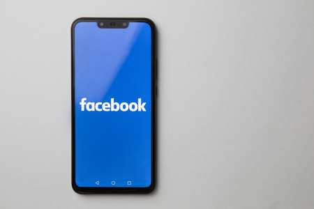 Kuala Lumpur, Malaysia - July 23, 2019: Smartphone showing Facebook logo on white backgroundのeditorial素材