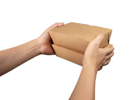 Hand giving takeaway cardboard food boxes to customer isolated on white