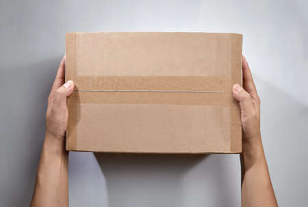 Top view of hand holds the package or parcel boxの写真素材