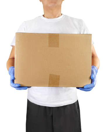 Home delivery shopping box man wearing gloves delivering packages at door.の写真素材