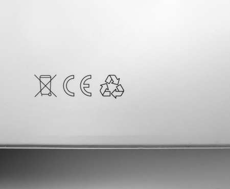 Close up of recyclable icon set printed on white box.