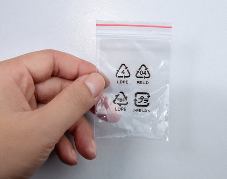 Hand holding a plastic ziplock bag isolated on white backgroundの写真素材