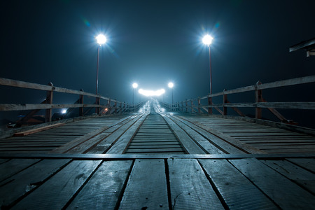 The old wooden bridge collapse Bridge across the river and Wood bridge (Mon bridge ) at sangklaburi night , kanchanaburi, Province Asia thailand (Smile bridge)の写真素材