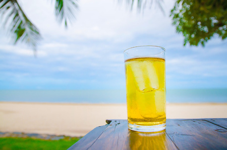 Cold beer on wooden in front the sea of Thailandの写真素材