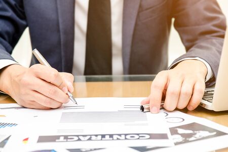 Close up business man signing contract making a finance deal