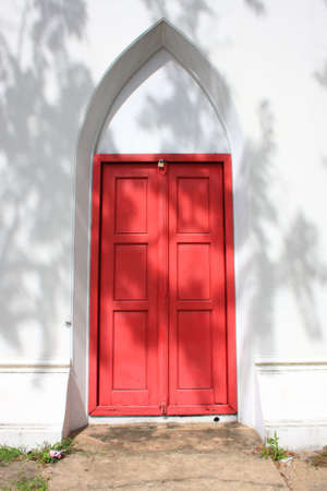 Red wooden doors of the stone cathedralの写真素材