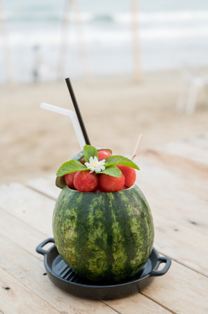 Watermelon smoothies with mint and grated watermelon pulp sever in watermelon on the woodentable.の写真素材
