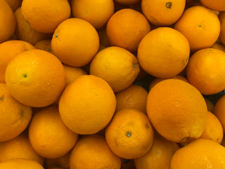 Group of not fresh and bruised valencia orange on the shelf in the fresh fruit zone at supermarketの写真素材