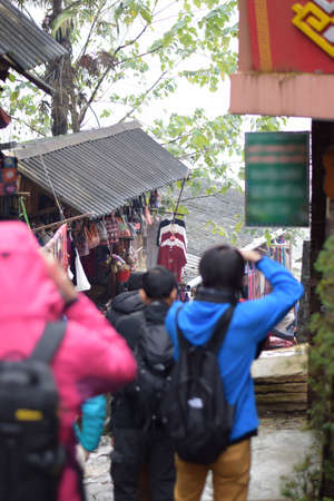 SAPA, Vietnam - December 5, 2015 : Tourist stop walking to take a picture of the native people near the street in the Cat Cat villageのeditorial素材