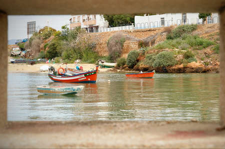 Fishing boats moored in the river at Ferragudo, Portugalの写真素材