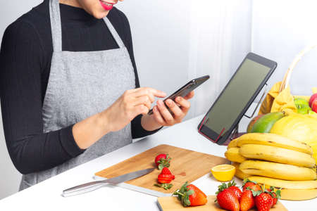 hand chopping a orange in a chop-board and squeezerの写真素材