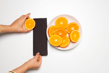 hand chopping a orange in a chop-board and squeezerの写真素材