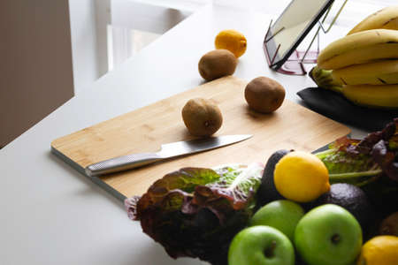 hand chopping a orange in a chop-board and squeezerの写真素材