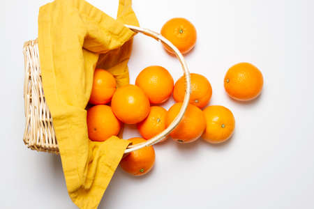 wicker basket with orange fallingの写真素材