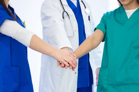 doctors with the hands above hands togetherの写真素材