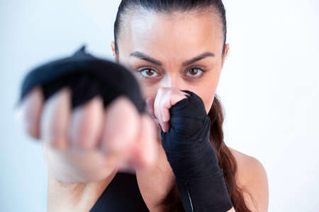 attractive woman looking to the camera with a boxing position punching to the cameraの写真素材