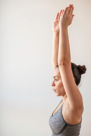 Woman stretching on the yoga mat on her houseの写真素材